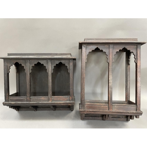 359 - An oak Indian style wall shelf bracket having carved arched windows together with another, 32cm wide... 