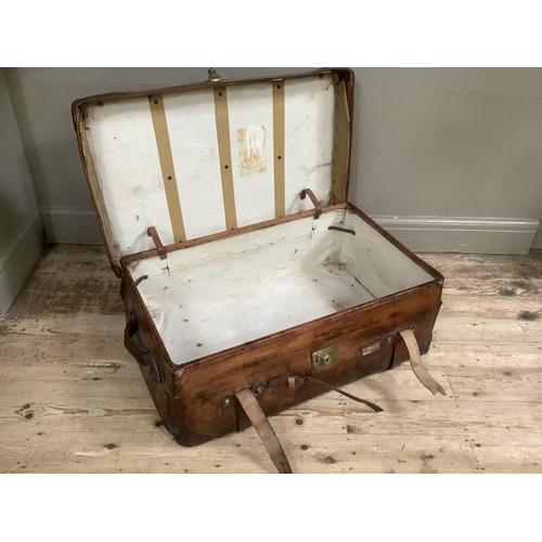 361 - A large vintage leather suitcase with straps, 84cm wide