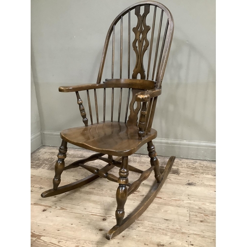 366 - An elm reproduction windsor high back rocking chair