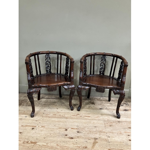 367 - A pair of Chinese heavily carved hardwood armchairs with bamboo and fruiting vine back supports on h... 