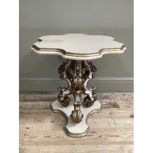 373 - A reproduction French style cream and gilt occasional table having heavily carved 'C' scroll triped ... 