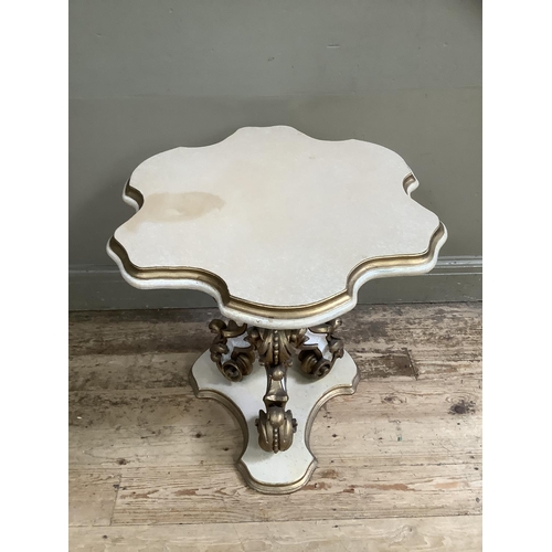 373 - A reproduction French style cream and gilt occasional table having heavily carved 'C' scroll triped ... 