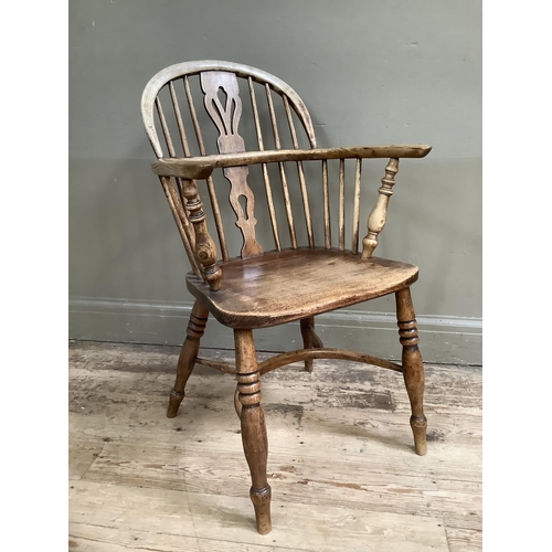 377 - A 19th century elm low back windsor chair on turned legs