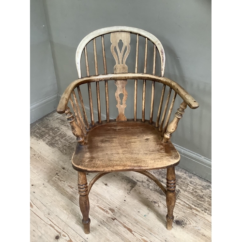 377 - A 19th century elm low back windsor chair on turned legs