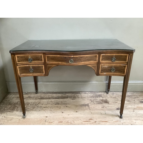 389 - An Edwardian mahogany crossbanded dressing table, with serpentine front having a long drawer to the ... 