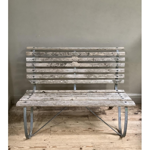 393 - A garden bench on metal scroll supports, 122cm wide