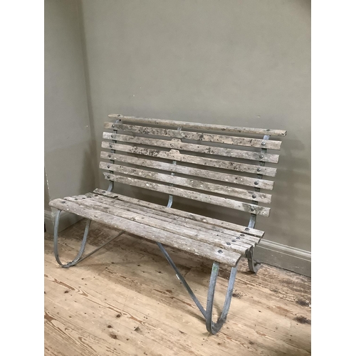 393 - A garden bench on metal scroll supports, 122cm wide