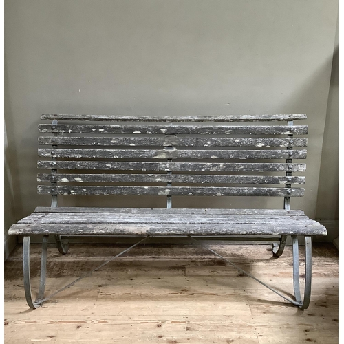 394 - A garden bench on metal scrolls supports 152cm wide