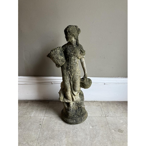 395 - A cast garden sculpture of a woman in a dress carrying baskets of flowers, 76cm high