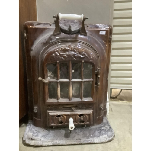 391 - A cast iron and glazed ceramic stove