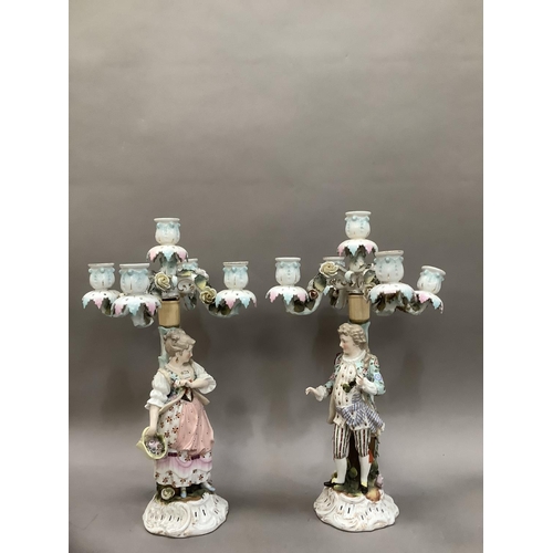 94 - A pair of 19th century continental porcelain five sconce candelabras modelled as a lady and gentlema... 