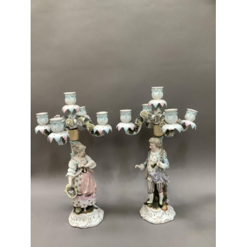 94 - A pair of 19th century continental porcelain five sconce candelabras modelled as a lady and gentlema... 