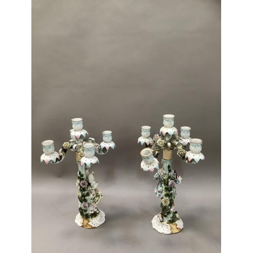 94 - A pair of 19th century continental porcelain five sconce candelabras modelled as a lady and gentlema... 