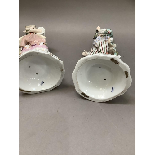 94 - A pair of 19th century continental porcelain five sconce candelabras modelled as a lady and gentlema... 