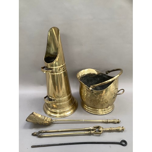 382 - A brass coal scuttle containing various fireside accessories including tongs, shovel and poker toget... 