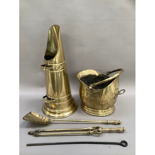 382 - A brass coal scuttle containing various fireside accessories including tongs, shovel and poker toget... 