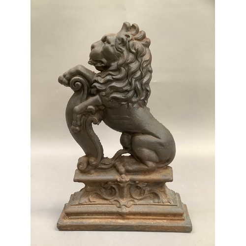 383 - A reproduction cast iron doorstop formed as a lion crest, 37cm high