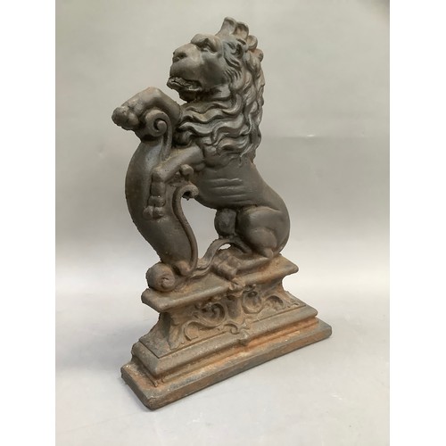 383 - A reproduction cast iron doorstop formed as a lion crest, 37cm high