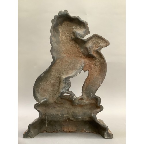 383 - A reproduction cast iron doorstop formed as a lion crest, 37cm high