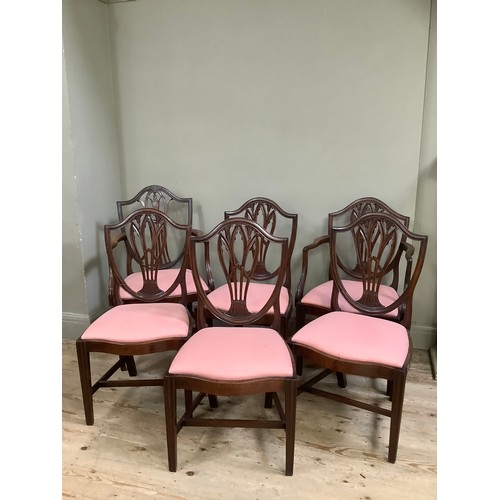 390 - Six  mahogany shield back dining chairs, serpentine seat rail, upholstered seat on fluted tapered le... 