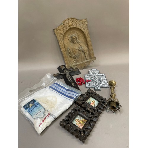 196 - A collection of devotional items to include a brass relief plaque of Christ, an ebonised crucifix, a... 