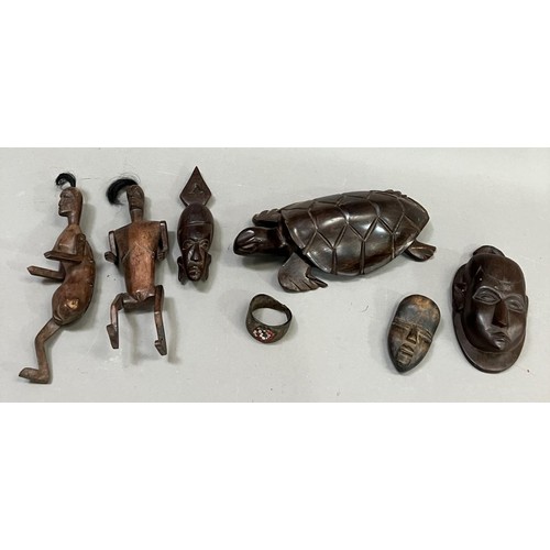 211 - A pair of hardwood Indonesian articulated dolls, male and female carved to the back with turtle and ... 