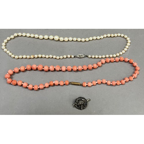 266 - A mid 20th Century coral necklace of 5.5mm spherical beads, approx. length 36cm, fastened with a 9ct... 