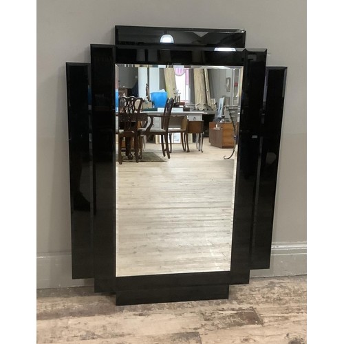 340 - A mid-century rectangular wall mirror with bevelled glass the frame formed of black perspex geometri... 