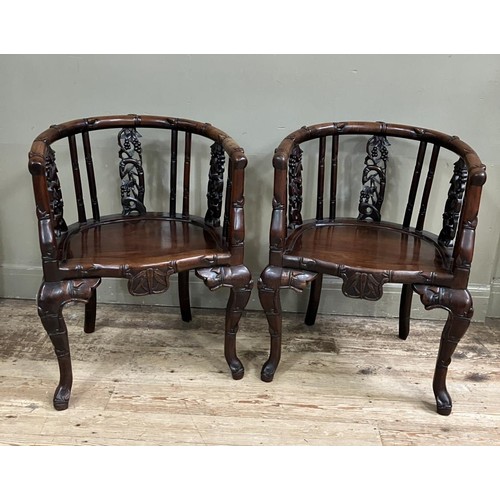 367 - A pair of Chinese heavily carved hardwood armchairs with bamboo and fruiting vine back supports on h... 