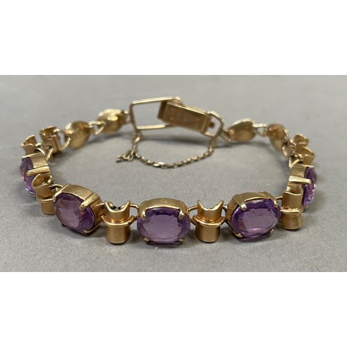 281 - An Amethyst bracelet, the five oval facetted stones claw set to links alternating bamboo style links... 