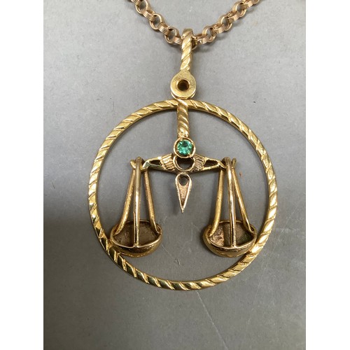 270B - A Libra Zodiac star sign pendant in 9ct gold, the scales in relief with a circular rope twist surrou... 