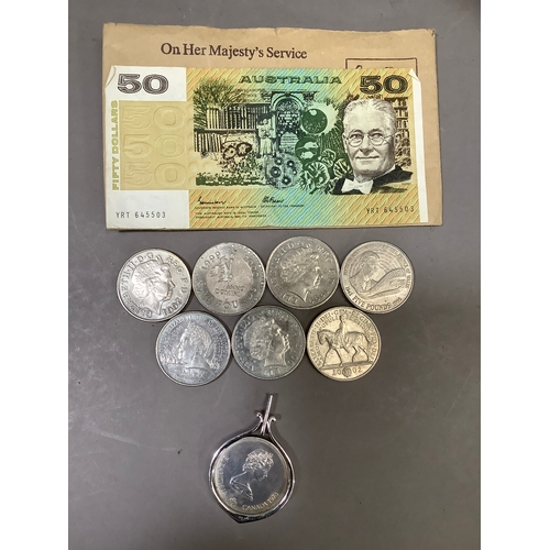 261B - A Canadian Olympic dollar , an Australian 50 dollar note and seven UK pound coins