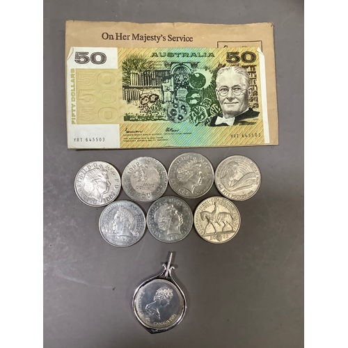 261B - A Canadian Olympic dollar , an Australian 50 dollar note and seven UK pound coins