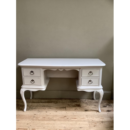 88 - A cream painted serpentine fronted dressing table having two drawers to either side of a kneehole, o... 