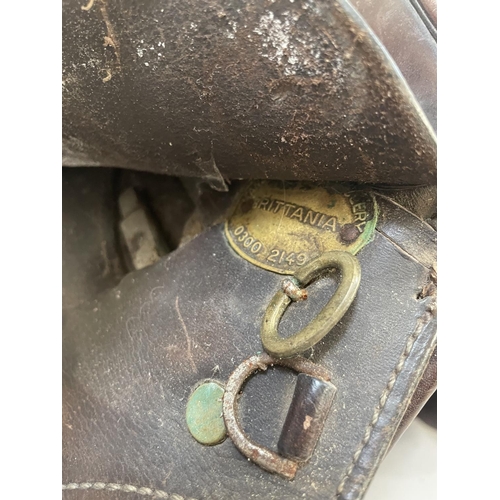 485 - A leather saddle stamped Britannia together with a bridle, reins bit and stirrups