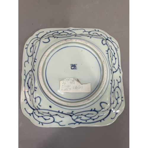 27 - A Japanese Arita dish, square outline painted to the centre in under glazed blue with island pavilio... 