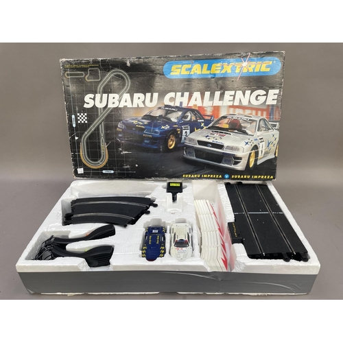 487 - A Scalextric Subaru Challenge together with a collection of slot racing track some boxed