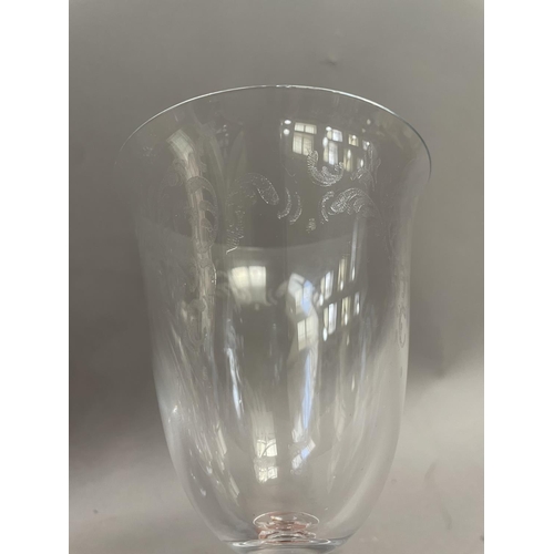 121 - A suite of twelve wine glasses having flared rims with etched bowls on knopped setms