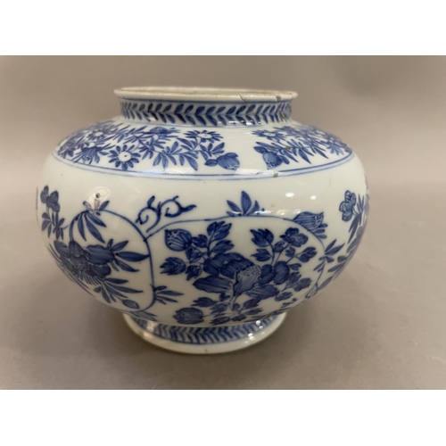 14 - A Chinese blue and white vase, the body painted with chrysanthemums and scrolling tendrils, on pedes... 