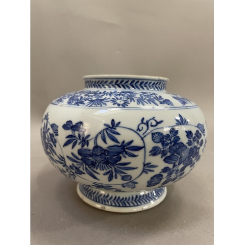 14 - A Chinese blue and white vase, the body painted with chrysanthemums and scrolling tendrils, on pedes... 