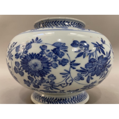 14 - A Chinese blue and white vase, the body painted with chrysanthemums and scrolling tendrils, on pedes... 