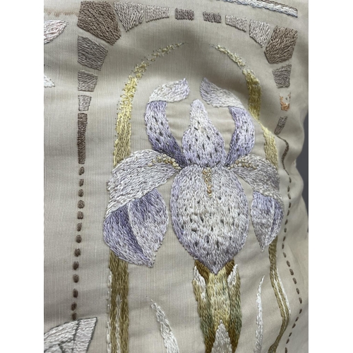 54 - A large silk cushion, the front embroidered with two bearded iris and a butterfly, having rope edgin... 