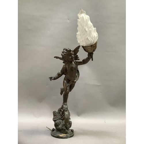 36 - After Emile Bruchon, a spelter table lamp formed as a winged cherub holding a flaming torch, stood a... 