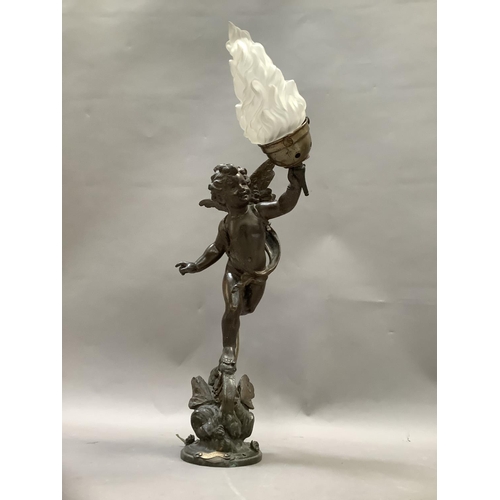 36 - After Emile Bruchon, a spelter table lamp formed as a winged cherub holding a flaming torch, stood a... 