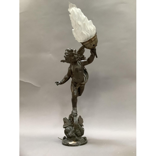 36 - After Emile Bruchon, a spelter table lamp formed as a winged cherub holding a flaming torch, stood a... 