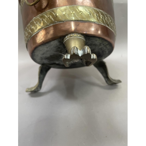 42 - A copper and brass banded jardiniere having lion mask ring pull handles on three paw feet, 24.5cm hi... 