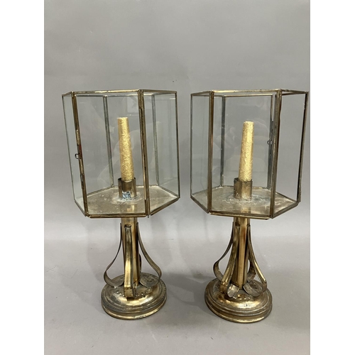 11 - A pair of brass lanterns, having strapwork supports, 40.5cm