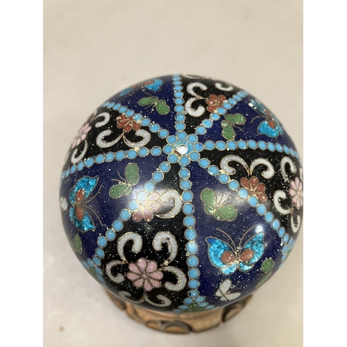 2 - A cloisonne jar and cover having insects and flowers on a green, blue and black ground, 11cm high in... 