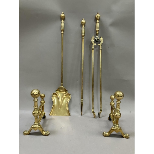 70 - A Victorian brass fireside companion set together with two firedogs