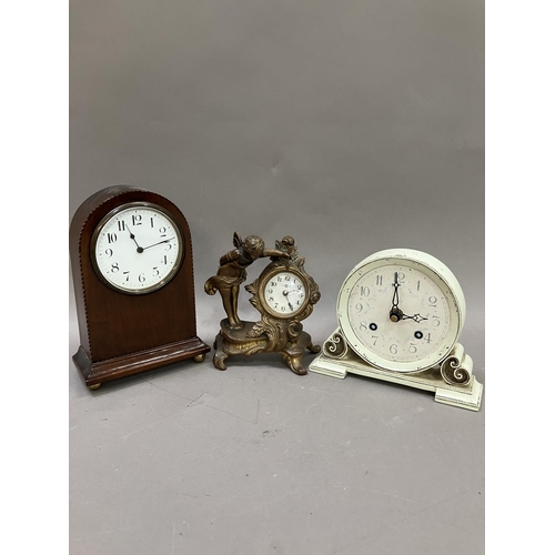 120 - A mahogany crossbanded mantel clock, a gilt metal boudoir clock formed as a winged cherub and anothe... 